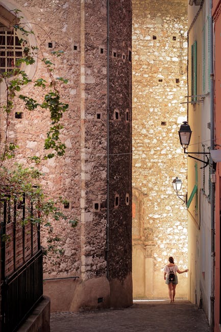 siena narrow street stone walls afternoon light